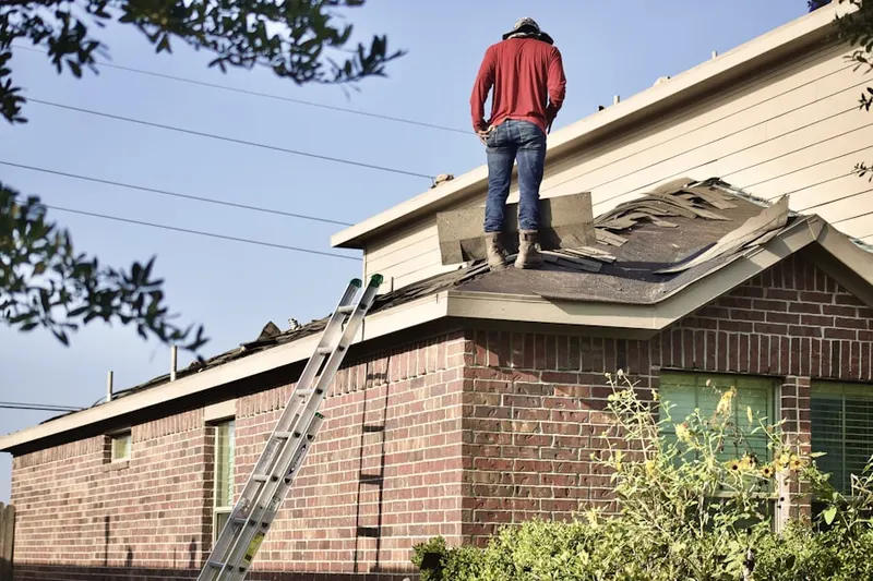 Professional roofer working on a residential roof in Gromore